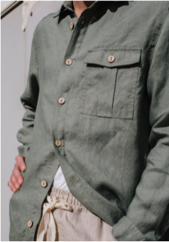 Front view of a man showcasing a solid khaki olive green 100% pure linen casual long-sleeve button-up shirt with front chest utility patch pockets.