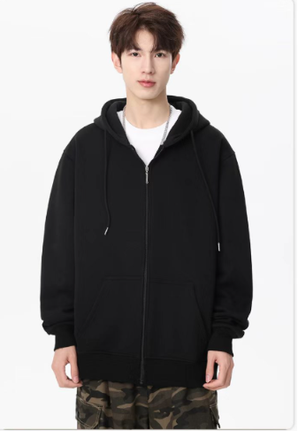 Front view of a man showcasing a classic black zip-up hooded jacket with white drawstrings layered over a white t-shirt and camouflage pants.